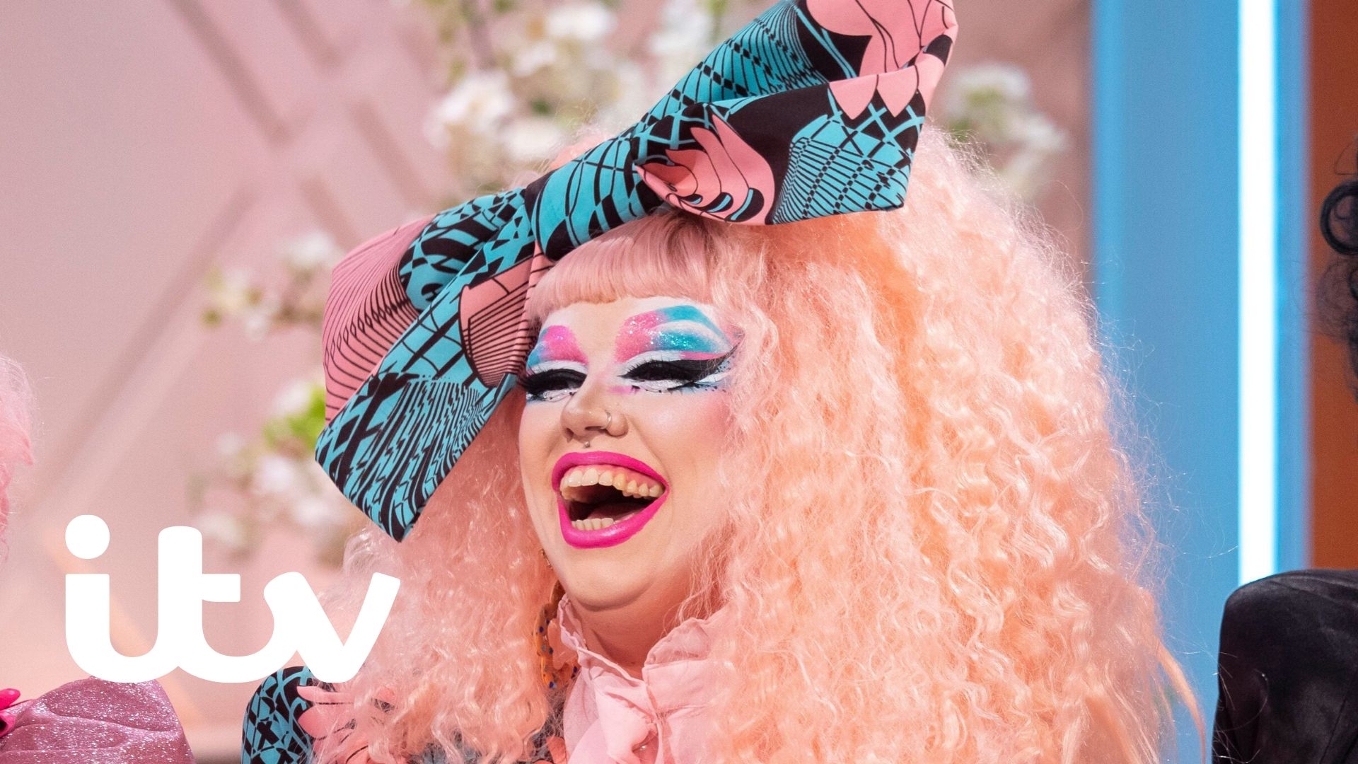 Drag Queen Cheddar Gorgeous, laughing.